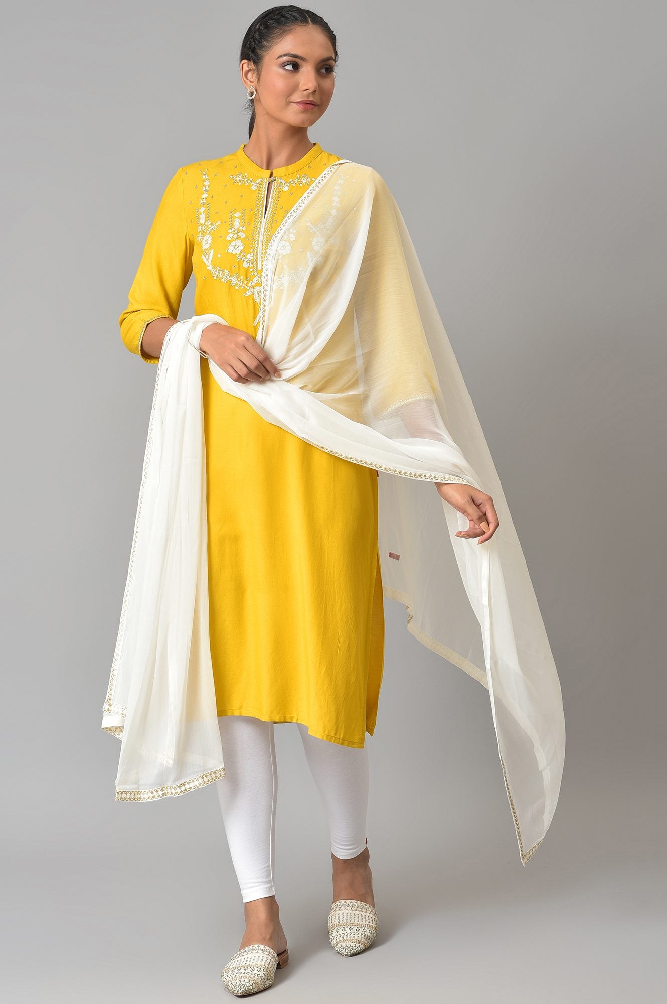 Yellow Embroidered kurta With White Tights And Dupatta.