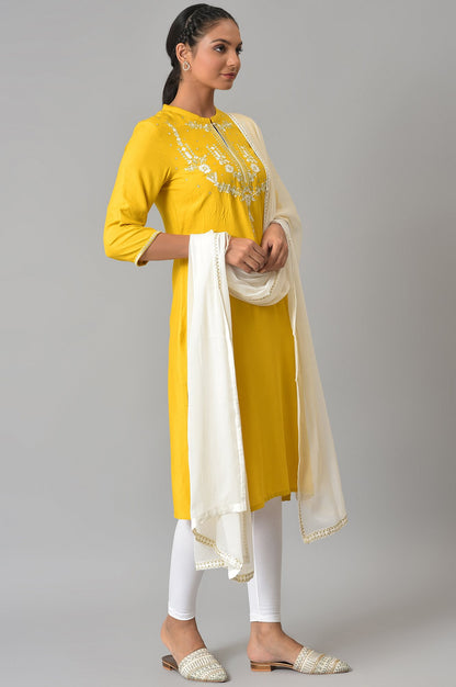 Yellow Embroidered kurta With White Tights And Dupatta.