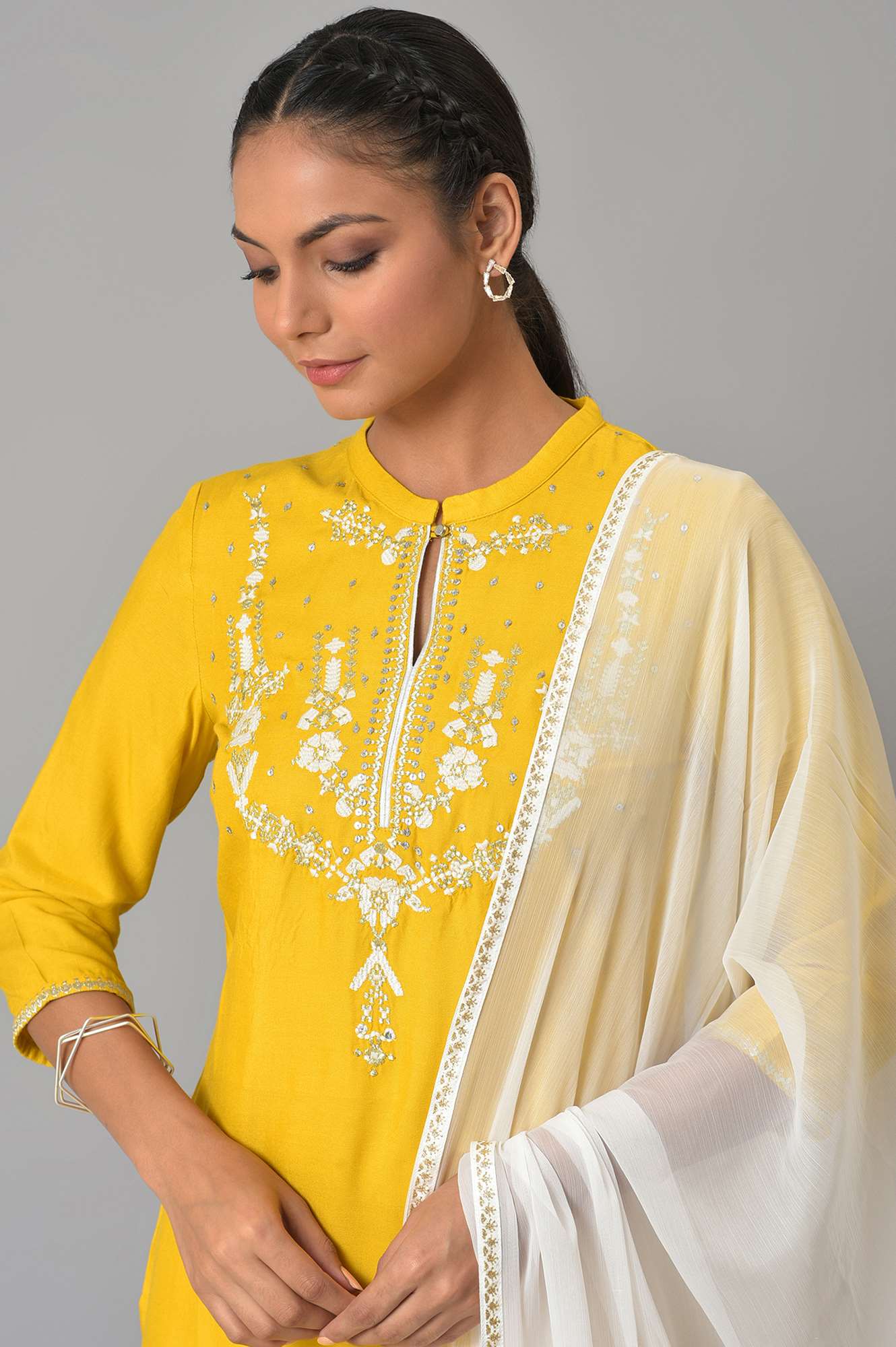 Yellow Embroidered kurta With White Tights And Dupatta.