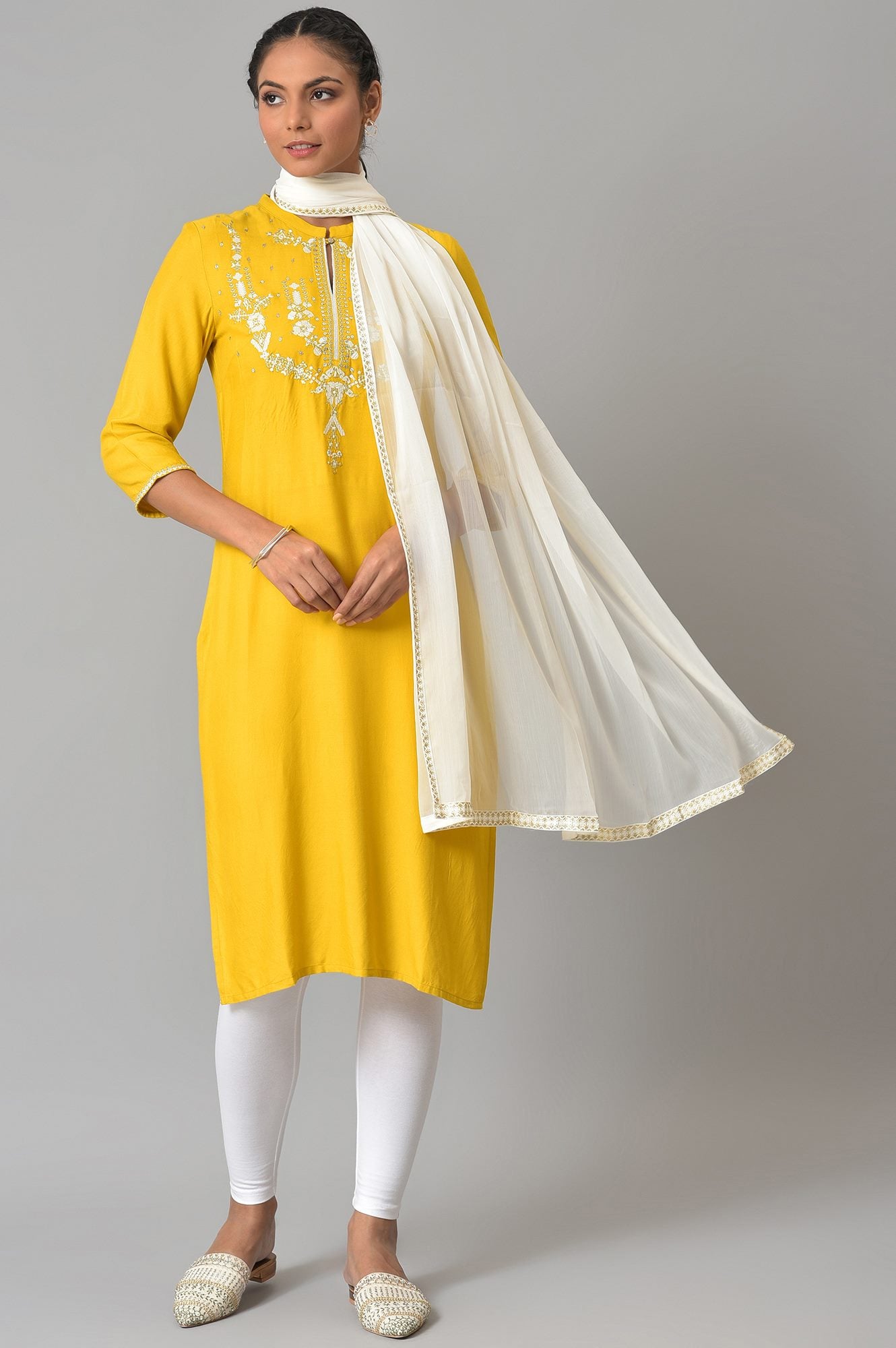 Yellow Embroidered kurta With White Tights And Dupatta.