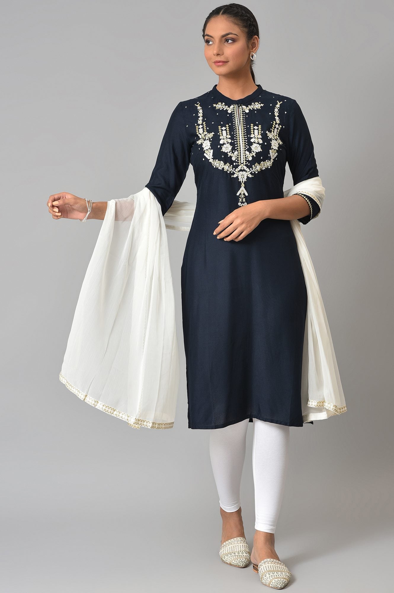 Dark Blue Embroidered kurta With White Tights And Dupatta.