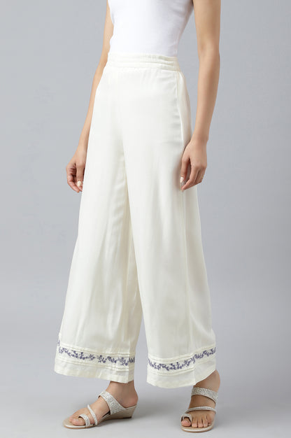 Ecru Embroidered Rayon Parallel Pants With Pleats.