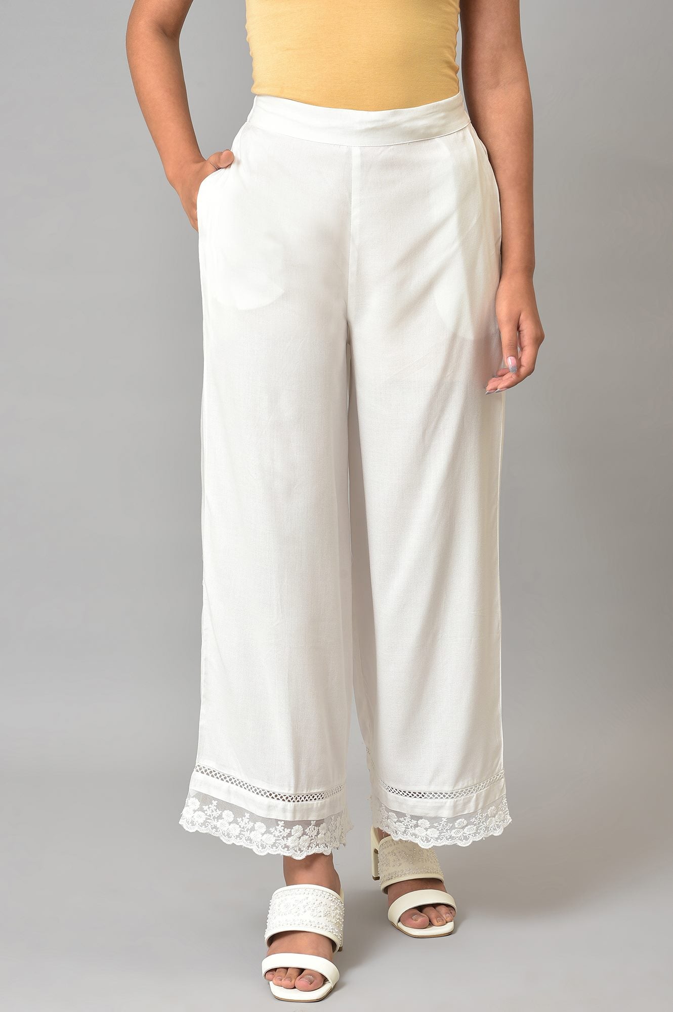 Ecru Parallel Pants With Lace At Hemline